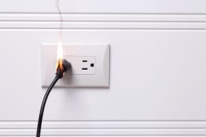 plug connected to mains on fire